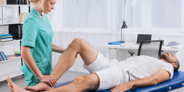 Female Massage Therapist Doing Leg Massage