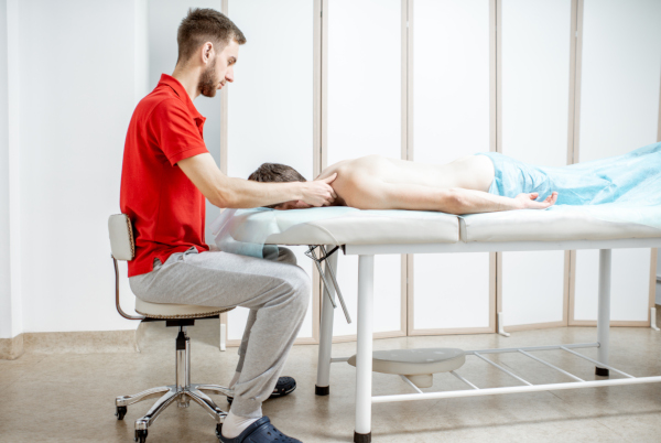 massage therapist working on client