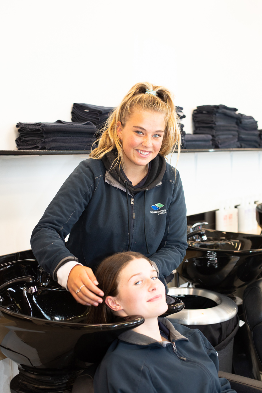 Tahlee and Nora practicing hair treatment techniques on each other