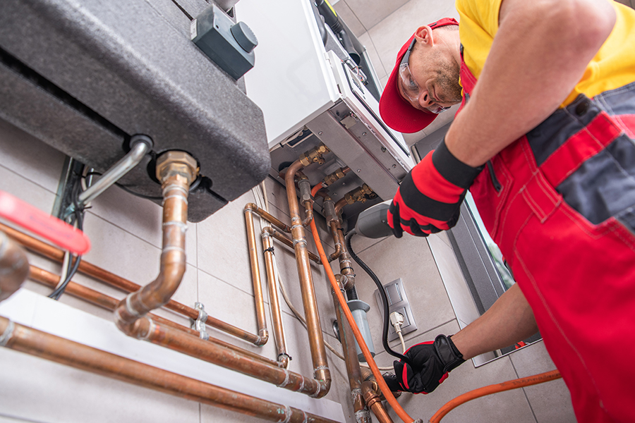Plumber working on gas heating
