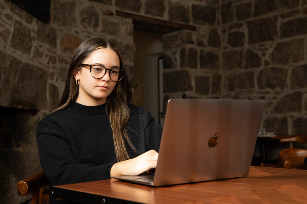 Eliza Hoy working on a laptop